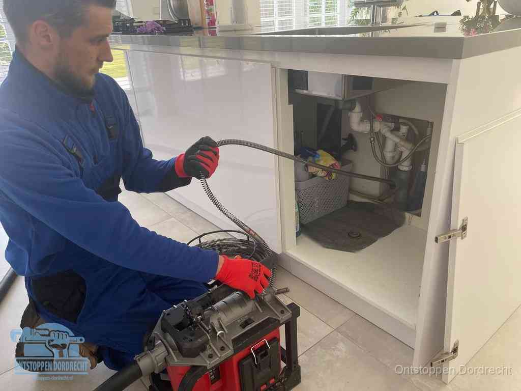 Een monteur reinigt de keukenafvoer grondig met een veermachine om terugkerende gootsteenverstoppingen te voorkomen in Dordrecht